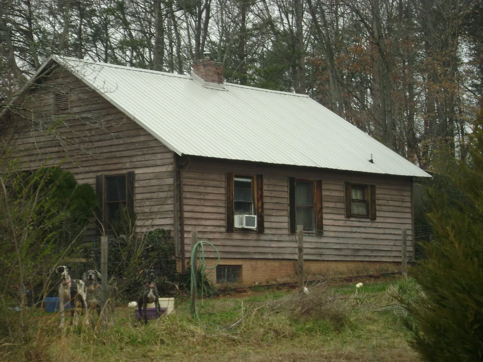 White metal roof on an old wood sided farmhouse, from a Metal Roof Installation job in Soldier
